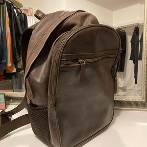 Leather backpack with 3 exterior zipper pockets and 1 interior zippered sleeve